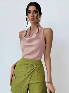 Elegant pink satin sleeveless cowl neck shirt paired with green textured trousers