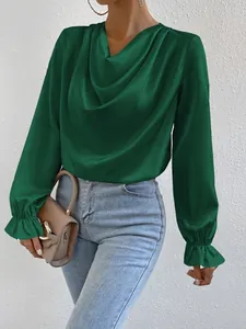 Detail of a green satin cowl neck blouse with ruffled cuffs and long sleeves.