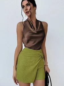 Elegant sleeveless brown satin top paired with a stylish textured green skirt..