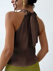 Detail view of a brown satin sleeveless halter neck top with a stylish bow at the back