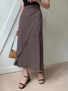 Elegant brown satin midi skirt with a stylish wrap design and silky smooth finish