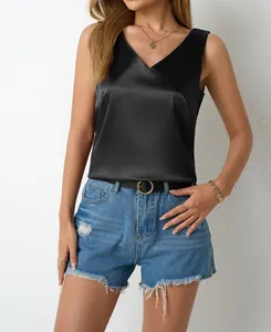 Detailed view of a black satin V-neck sleeveless top with smooth glossy texture.