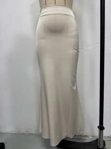 Detailed macro view of an elegant beige satin high-waisted maxi skirt with silky texture