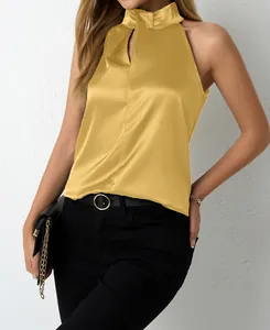 Detailed macro view showing the glossy texture of a gold satin halter neck top