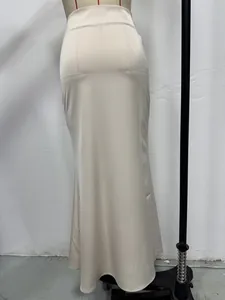 Back view of an elegant champagne satin maxi skirt on a professional mannequin.