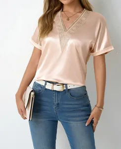 Close-up detail of an elegant V-neck satin blouse with delicate lace trim and short sleeves