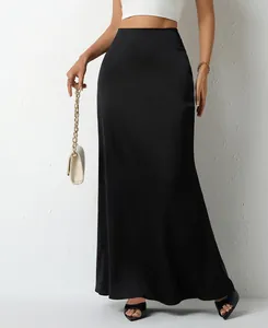 Detail view of smooth black satin maxi skirt featuring an elegant and flowing drape