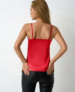 Back view of a vibrant red satin camisole with adjustable straps and silky texture