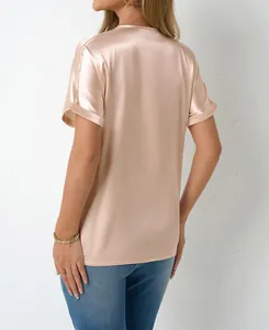 Back view of a champagne satin short-sleeve blouse with a smooth silk-like finish