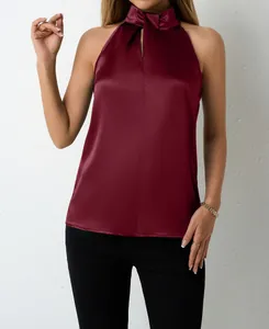 Detail showing the smooth texture and high collar of the burgundy satin halter neck top.