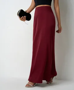 Detail shot of an elegant burgundy satin maxi skirt featuring a smooth high waist design