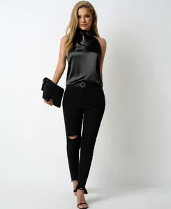 Detail view of a chic black satin halter neck top for women in a sleek minimalist outfit