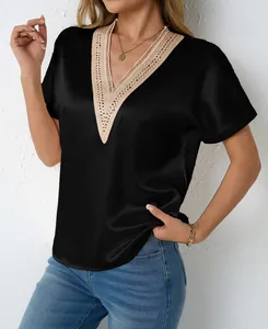 Detailed view of women's black satin V-neck blouse with intricate lace neckline trim.