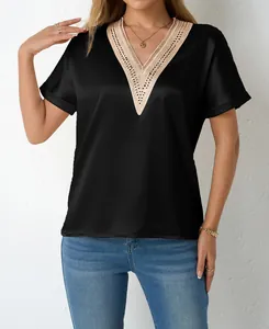 Detail view of black satin V-neck blouse with intricate lace trimming and loose fit.