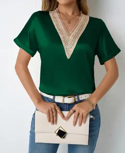 Detail view of a women's green satin V-neck blouse featuring intricate beige lace trim