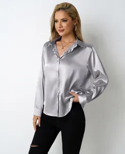 Detailed view of a silver satin long sleeve V-neck shirt for women in a studio setting