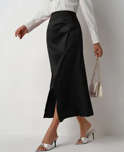 Detail view of a black high-waisted satin skirt with a stylish side slit and pleated accents