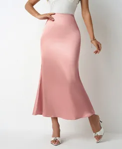Detailed macro view of the elegant pink satin mermaid midi skirt showing fabric texture