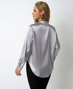 Back view detail of an elegant silver satin long-sleeved blouse with high-shine fabric texture