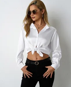 Detailed close-up of a white satin long sleeve shirt with a front-tie knot and V-neck