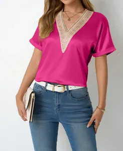 Close-up detail of bright pink satin V-neck blouse with intricate lace crochet trim