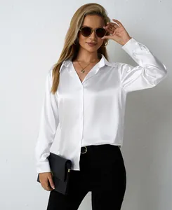Detail of women's white satin long-sleeve blouse with a glossy finish and loose fit.