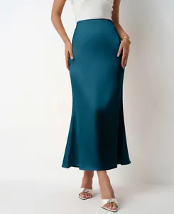 Detail view of teal satin midi skirt with elegant fishtail hem and glossy finish