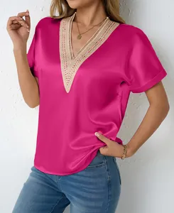 Close-up of fuchsia satin V-neck blouse featuring intricate gold lace trim details