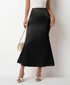 Detailed view of black satin fishtail midi skirt showing silky fabric texture