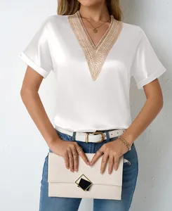 Elegant white satin V-neck blouse featuring intricate gold lace trim and a silky finish