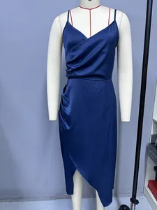 Close-up of navy blue satin camisole dress with elegant draped detail and side slit.