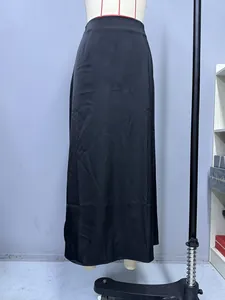 Detailed macro view of the elegant black satin long skirt fabric and drape on mannequin