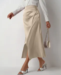 Detail shot of elegant champagne high waist satin skirt featuring side slit and pleated design