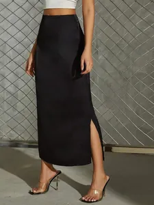 Close-up of black satin midi skirt featuring elegant side slit and smooth fabric texture.
