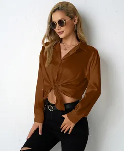 Detailed macro shot of women's brown satin blouse featuring a front tie knot design
