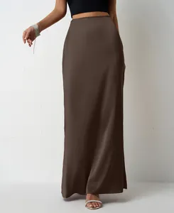 Elegant brown satin maxi skirt detail showing smooth sateen fabric texture on model