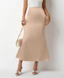 Detail view of champagne satin midi mermaid skirt showing elegant drape and fit