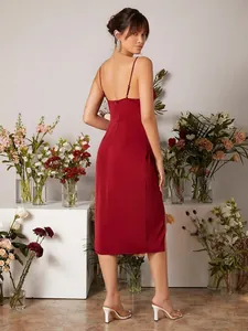 Back view of a red satin slip dress with adjustable straps and side slit