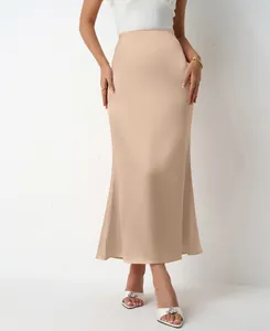 Detailed view of champagne satin midi skirt showing elegant fishtail hem and slim fit