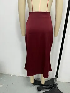 Back view of a elegant burgundy satin midi skirt displayed on a professional mannequin