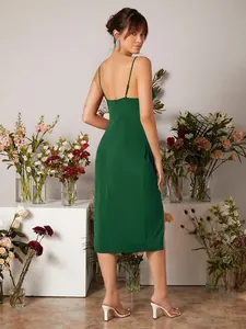 Back view of elegant dark green satin slip dress with slit and open back design