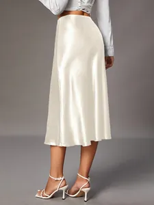 Elegant champagne satin midi skirt showing smooth silky texture and flattering back fit