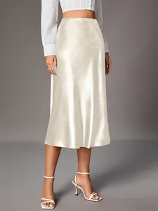 Elegant champagne satin midi skirt featuring a smooth silk-like texture on model
