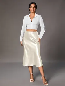 High-waist champagne satin midi skirt with elegant glossy finish and smooth drape texture