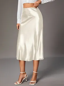 Detailed view of the champagne satin midi skirt showing elegant sheen and fluid drape