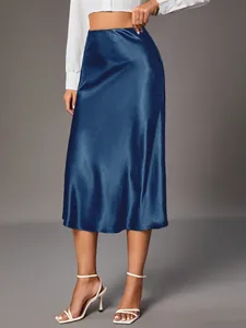 High-waisted navy blue satin midi skirt featuring a smooth silky finish and elegant drape