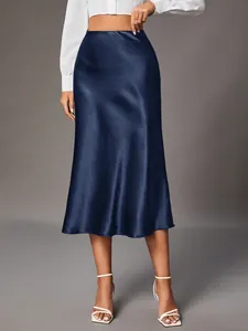 Close-up detail of a navy blue satin midi skirt featuring a silky glossy finish