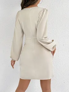 Detail view showing the back of a cream long-sleeved satin bodycon mini dress.