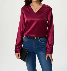Detail view of the elegant smooth wine red satin long-sleeve blouse with V-neckline