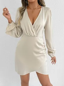 Close-up of elegant champagne satin mini dress with deep V-neck and long puff sleeves